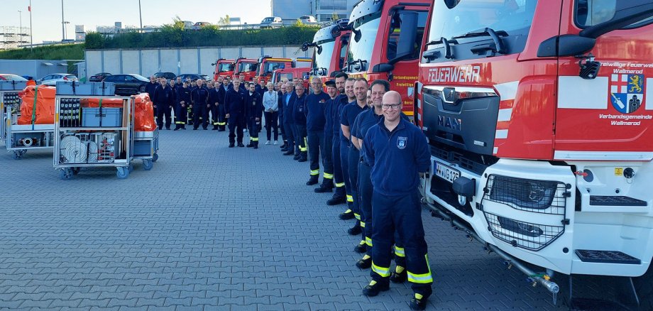 Vor dem Feuerwehrgerätehaus in Selters stehen mehrere Feuerwehrfahrzeuge, ihre Besatzung und die neuen vier Rollcontainer.