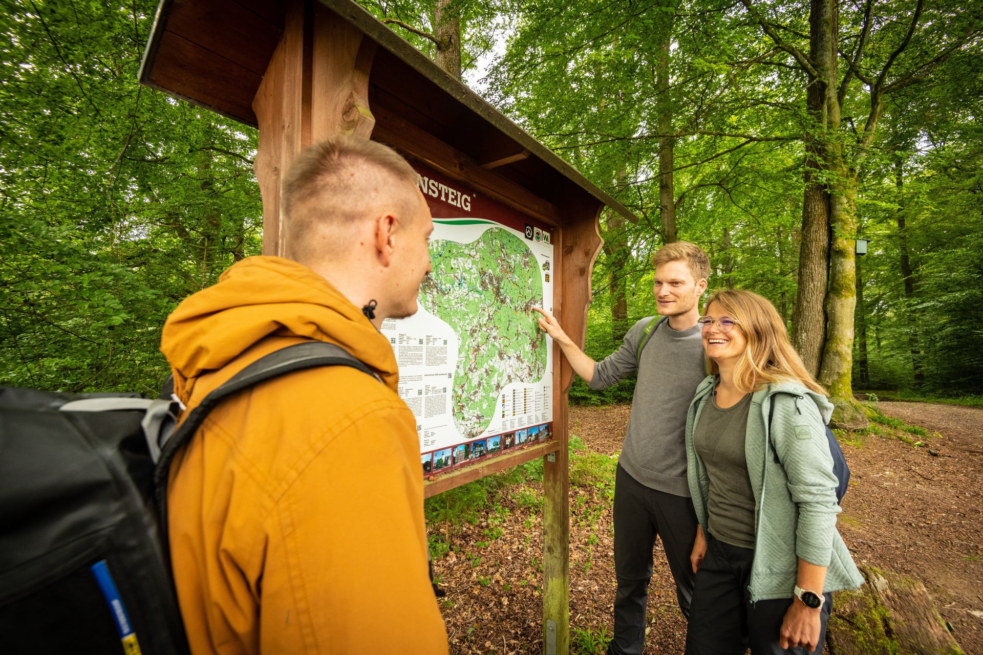 Wanderer stehen vor einem Schild des Druidensteigs.