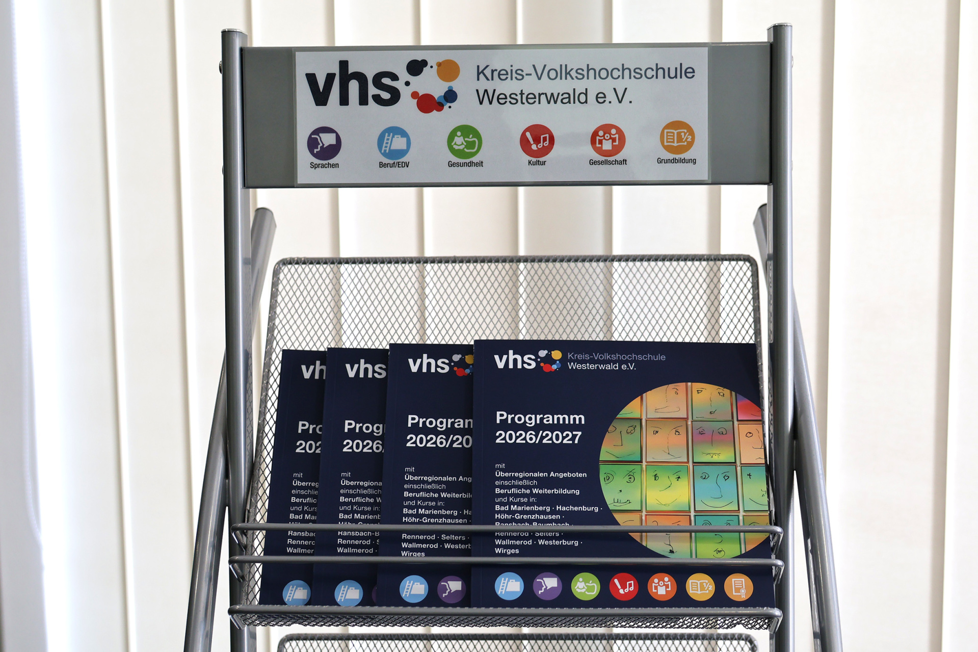 In einem Ständer liegen Kurshefte der Kreis-vhs.