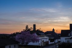 auf einer Anhöhe eine Burg bei Sonnenuntergang.